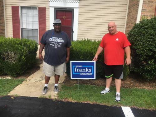 Red and Memphis Standing in Front of their New Apartment