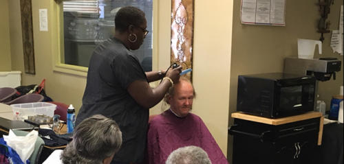Guest in our Day Center Receiving Free Haircuts from a Volunteer